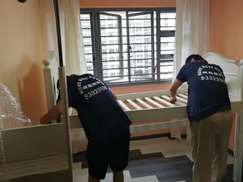 Bed frame being dismantled inside an HDB flat before mattress disposal in Singapore