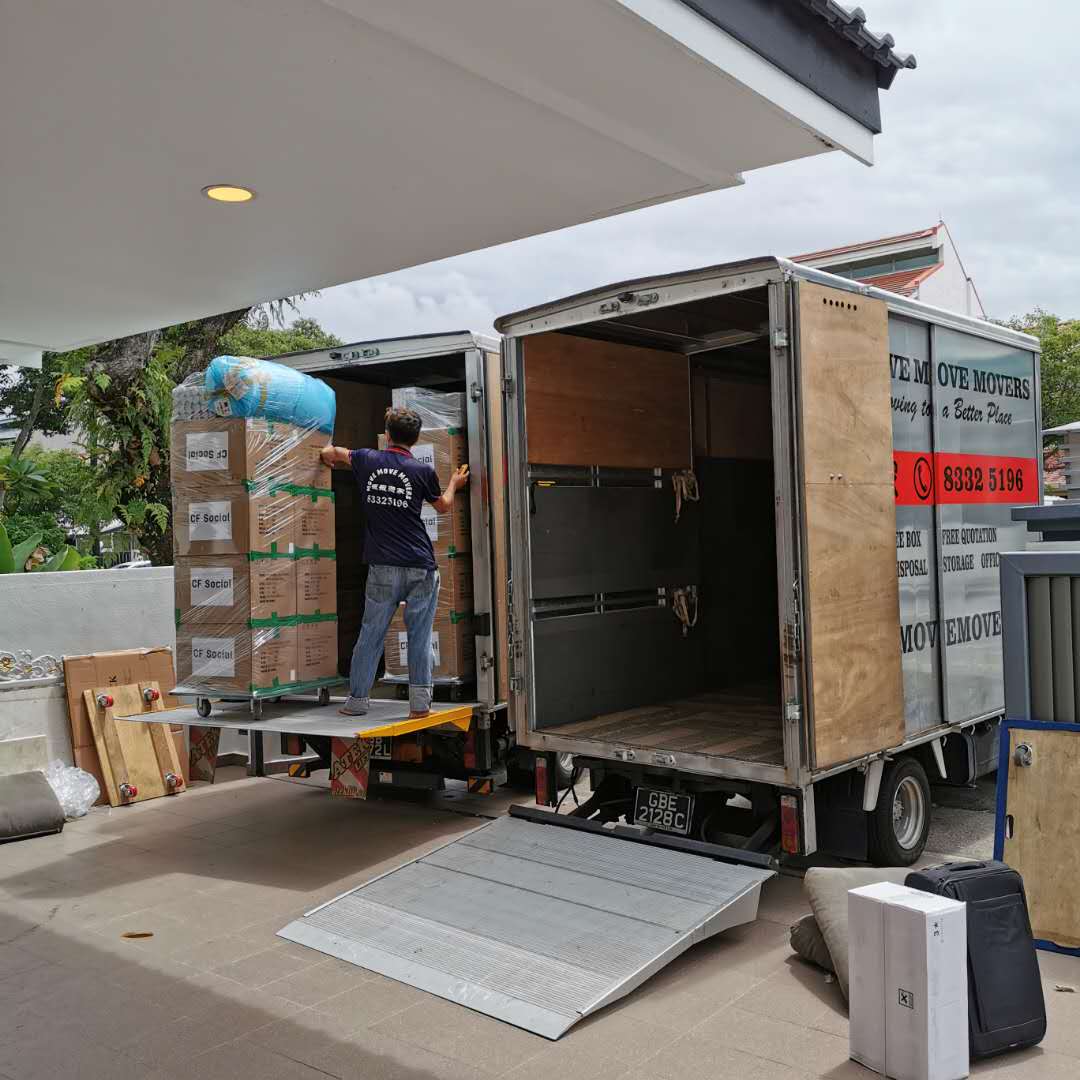 Move Move Movers loading palletised carton stacks into a moving truck with a tailgate