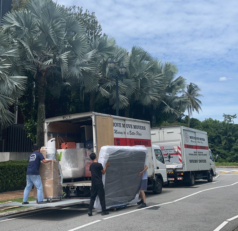 Move Move Movers team loading wrapped bulky items into branded trucks in Singapore