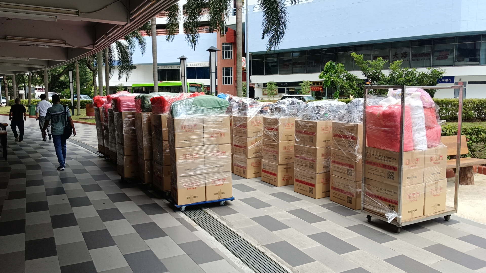 Protected office carton staging for commercial relocation – move move movers – move move movers Office cartons and wrapped items staged for a Singapore office relocation by Move Move Movers