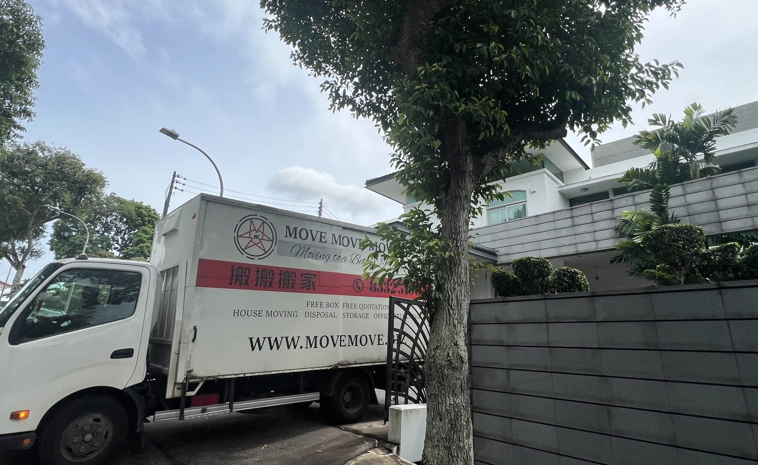 Move Move Movers truck parked beside a residential property for a whole-home clearance in Singapore