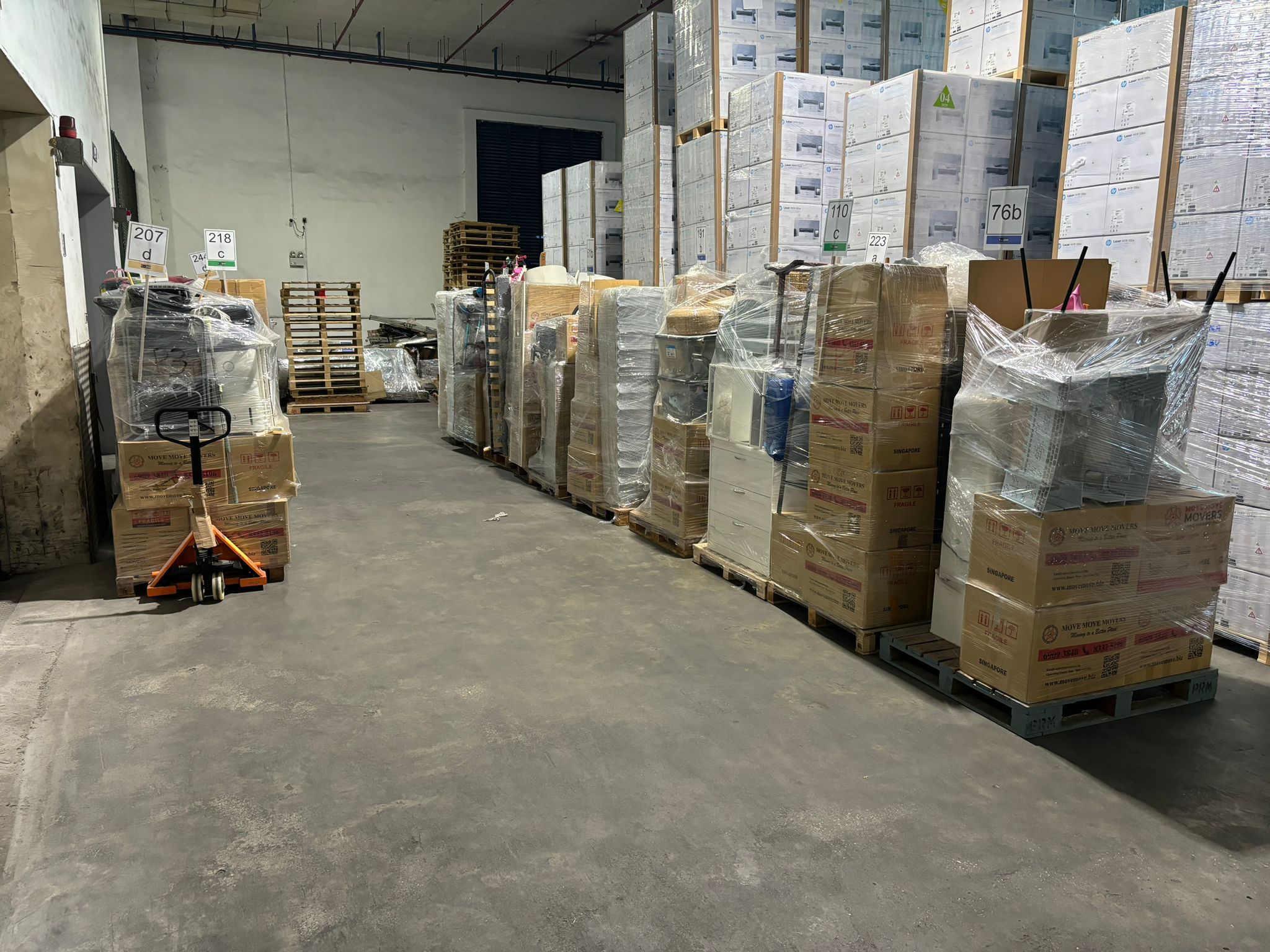 Wrapped furniture and household items stored on pallets during a Singapore renovation storage move