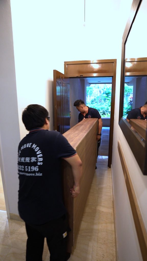 Tall panel transfer in corridor – move move movers – move move movers Move Move Movers crew carrying a tall wooden panel through a narrow corridor